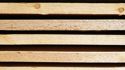 Stacked pine lumber, sawn boards as background