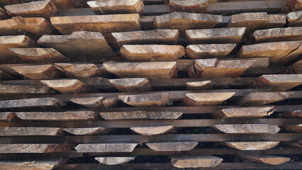Stacked pine timber, sawn raw boards as background