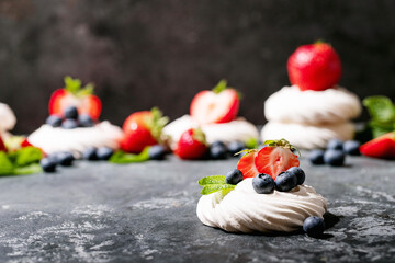 Dessert pavlov with strawberries and blueberries