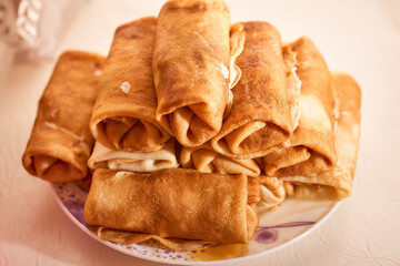 Homemade flour pancakes in a white plate. Close-up. With copy space.