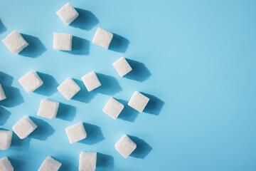Top view of white sugar on blue table
