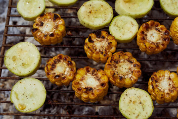 Vegetables, zucchini, yellow corn lies on the grill. Top view. With copy space.