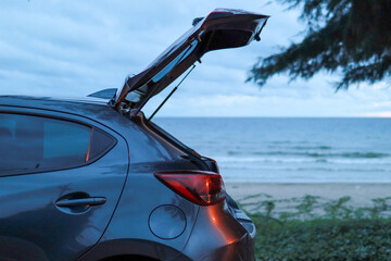 Open the hatchback door with a sea view. Travel, Lifestyle - obrazy, fototapety, plakaty