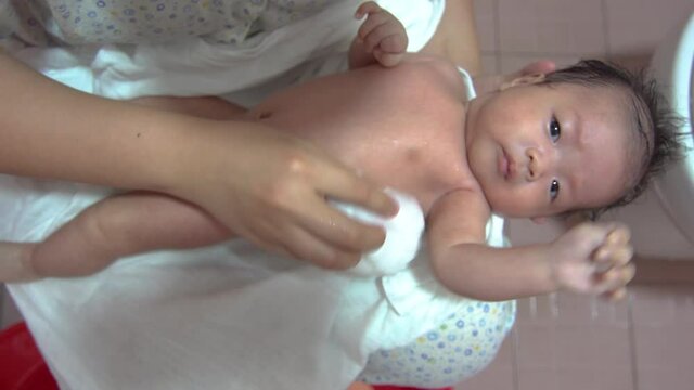 Point of view footage adorable newborn baby boy having bath with mother, Hygiene and health care for newborn baby.