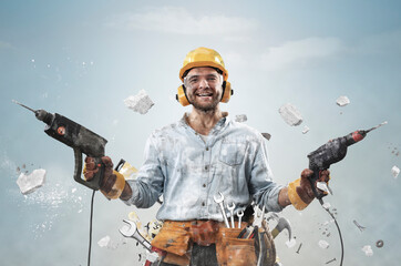Builder, Construction worker in dirty clothes with a hammer and drill at work