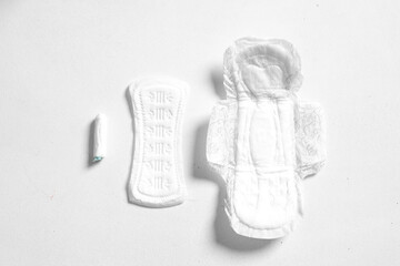 Soft white women's pads and tampon isolated on white background. Close up photography for women's or feminist blog