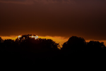 Dramatic orange evening sky with clouds at sunset