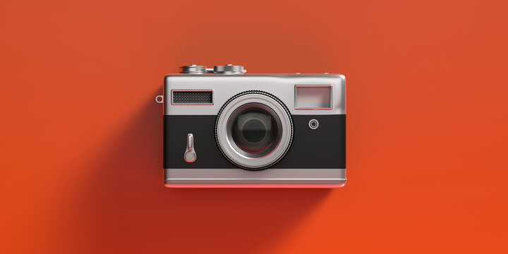Vintage film photo camera isolated on orange color background. 3d illustration