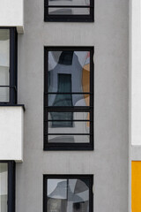 Facade of a building with glittering windows.
