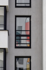 Facade of a building with glittering windows.
