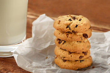Tasty cookies and glass of milk on  wooden background