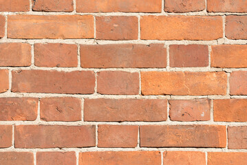 Fototapeta premium Red brick wall, abstract texture close-up