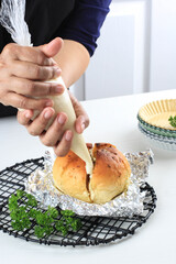 Korean Garlic and Cheese Bread (Yugjjog Maneulppang) is Popular Street Food in Korea. Made from Bread Bun, Cream Cheese, Garlic, Parsley, and Honey