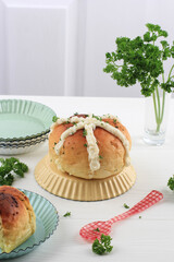 Korean Garlic Cream Cheese Bread (Yugjjog Maneulppang) is Popular Street Food in Korea. Made from Bread Bun, Cream Cheese, Garlic, Parsley, and Honey. White Concept Bakery