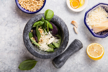 Pesto sauce in  mortar. Basil, olive oil, parmesan, garlic, pine nuts.