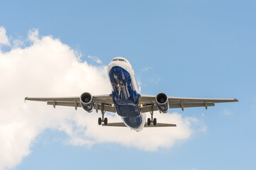 Fototapeta premium passenger jet airliner with undercarriage down landing at an airport