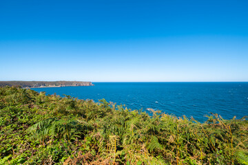 ride on the GR34 in Brittany with far off Cape Frehel and its lighthouse