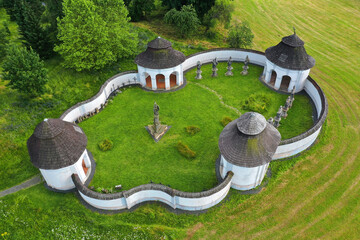 Old chapels, buildings and statues of saints at former small cemetery in Zdar nad Sazavou, Czech...