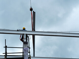 Man Working on the Working at height on construction site with blue sky