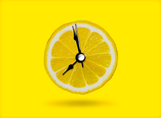 Lemon and the clock are the idea of ​​a healthy breakfast or a bright morning awakening.