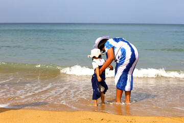 Beautiful kids girl traveling in holiday weekend on the beach at Phuket, Thailand.
