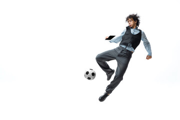 Man in office clothes playing football or soccer with ball on white background like professional player. Unusual look for businessman in jump kicking ball. Sport, healthy lifestyle, creativity.