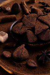 healthy delicious chocolate truffles around ingridients with natural cocoa beans,  powder, cacao butter, cane sugar. healthy sweets concept. close up