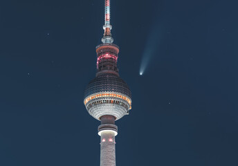 Neowise Comet visible in city of Berlin over TV tower with illuminated night sky. Astro photo...