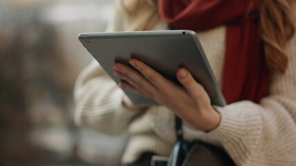 Unknown girl typing tablet computer outdoors. Woman hands holding digital tablet