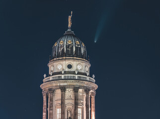 Neowise Comet visible in city of Berlin over Berlin Cathedral with illuminated night sky. Astro...