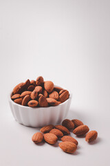 Almond in the cup, white background. Copy area