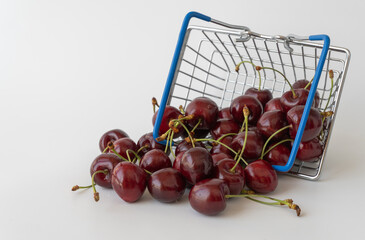 food basket with ripe cherries. concept of trading products, growth of prices for fruit
