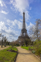 Early spring in the park at Champ de Mars in Paris. In the background - famous Eiffel Tower. Paris, France.