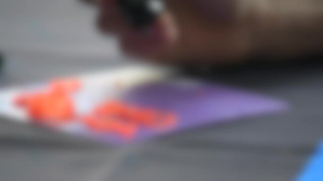 Blurred background. Drawing 3d pen draws with hardening photopolymer close-up