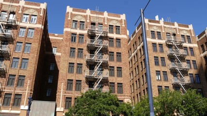 Fire escape ladder outside residential brick building in San Diego city, USA. Typical New York...