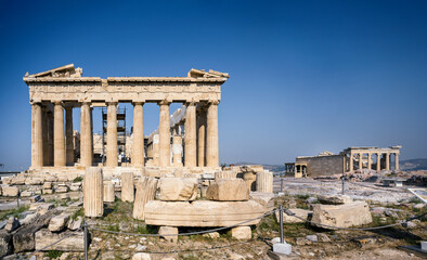 Obraz premium Panoramic view of the Parthenon and the Erechtheion of the Acropolis in Athens Greece shines in the warm sun before a blue sky and nobody is present.