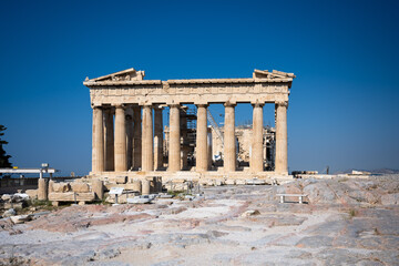 Obraz premium The Parthenon of the Acropolis in Athens Greece shines in the warm sun before a blue sky and nobody is present.