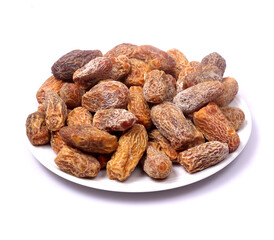 Dry dates or kharek on a plate with white background