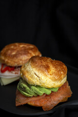 Assortment of homemade scones with ham, cheese, avocado, salmon, cream cheese and strawberry jam