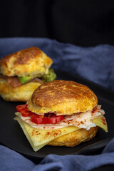 Assortment of homemade scones with ham, cheese, avocado, salmon, cream cheese and strawberry jam