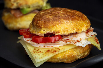 Assortment of homemade scones with ham, cheese, avocado, salmon, cream cheese and strawberry jam
