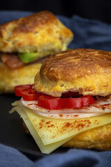 Assortment of homemade scones with ham, cheese, avocado, salmon, cream cheese and strawberry jam