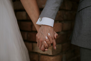 bride and groom holding hands