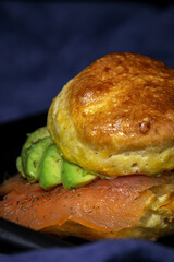Assortment of homemade scones with ham, cheese, avocado, salmon, cream cheese and strawberry jam