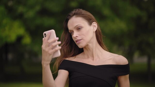 Beautiful woman is taking selfie on her smartphone