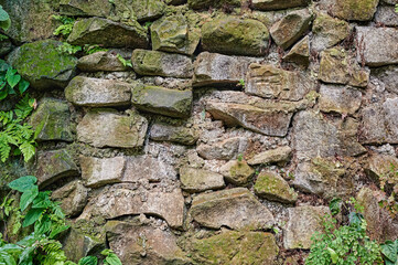 Background texture of  stone surface with green grass.
