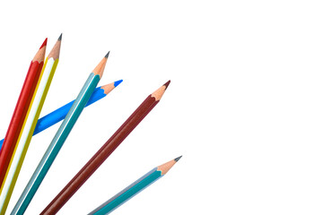 Six different colored wood pencil crayon scattered on a white background