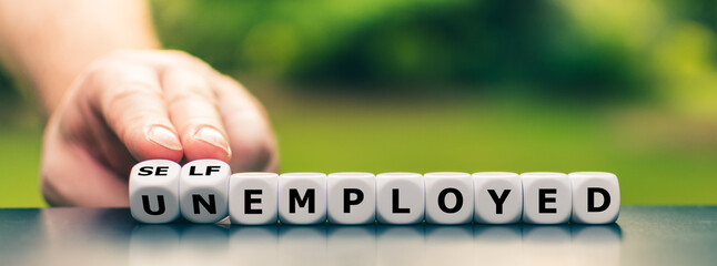 Hand turns dice and changes the expression "unemployed" to "self employed".