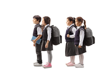 Group of four schoolchildren in uniforms