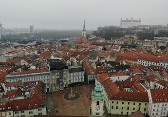 Fototapeta na wymiar Slovakia, Bratislava. Historical centre. Aerial view from above, created by drone. Foggy day town landscape, travel photography. Old city castle
